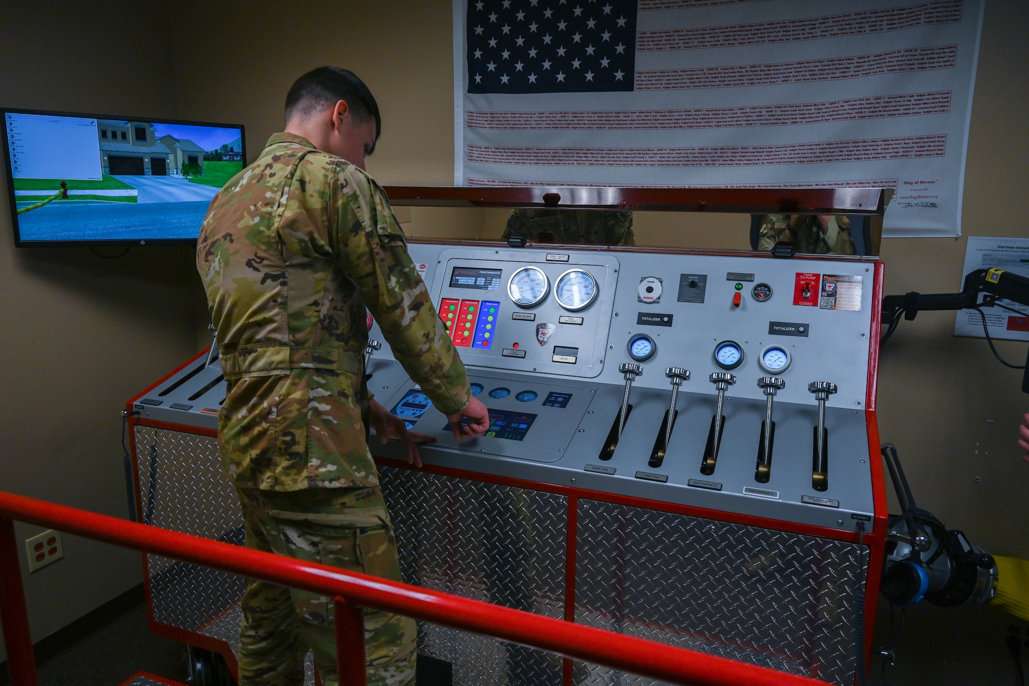 A man in uniform uses levers on a panel.
