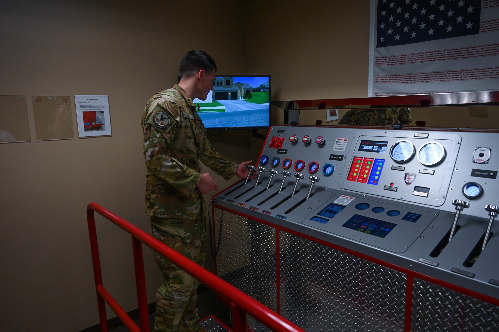 A man in uniform uses levers on a panel.