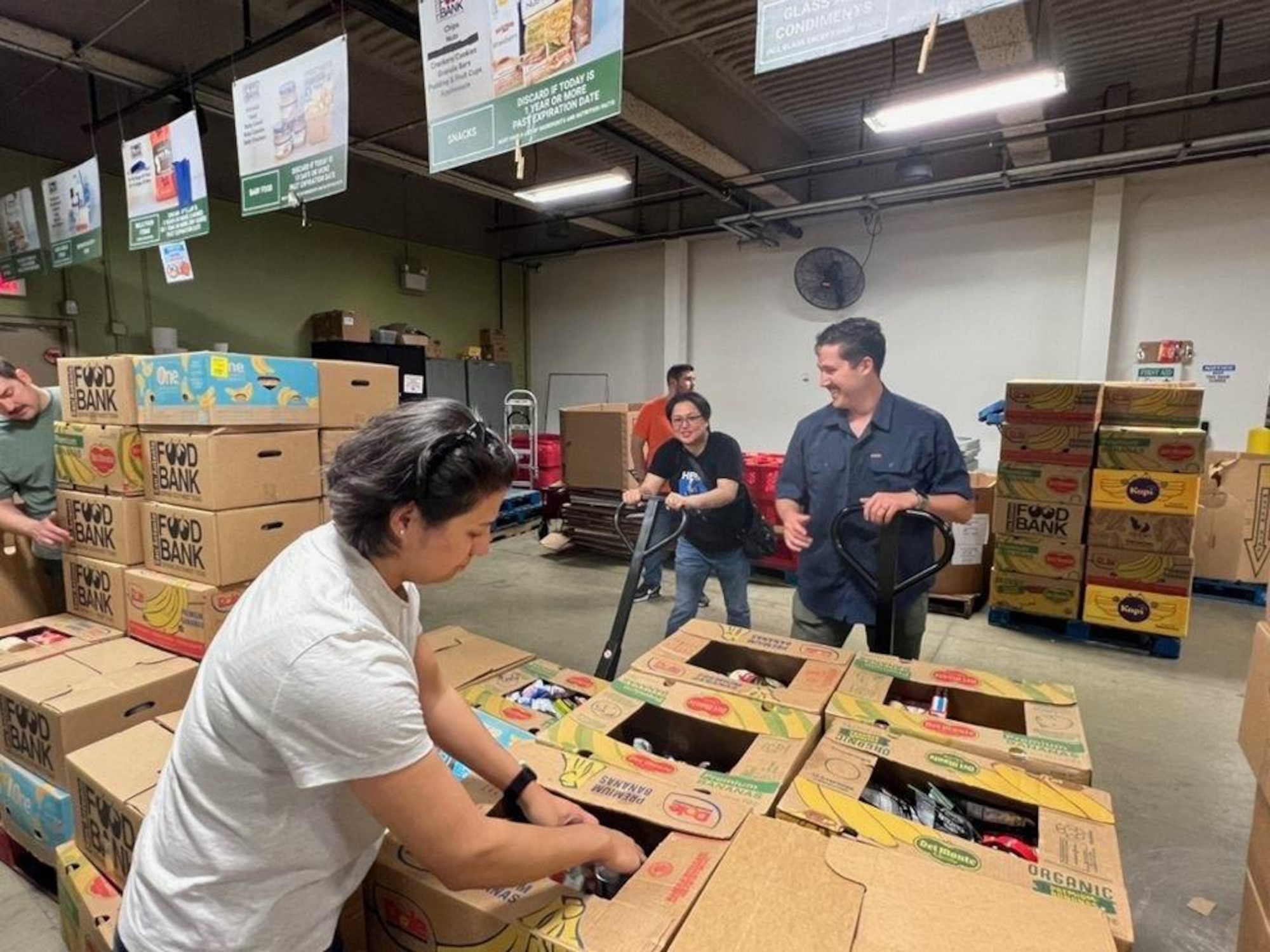 Student airmen and host members of the symposium prepare and package products to offer relief to food-insecure families and unsheltered persons at the San Antonio Food Bank on March 30, 2023. (Courtesy photo)