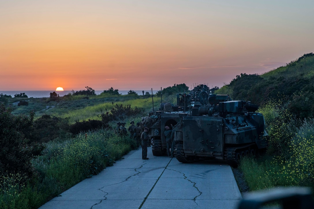 U.S. Marines with Apache Company, 1st Battalion, 5th Marine Regiment, 1st Marine Division, and A1 assault amphibious vehicles assigned to Charlie Company, 3rd Assault Amphibian Battalion, 1st Marine Division, prepare their vehicles before a simulated raid during 1/5’s MCCRE at Marine Corps Base Camp Pendleton, April 19, 2023. The purpose of a MCCRE, is to formally evaluate the unit’s core and/or assigned mission essential tasks to ensure service standardization and combat readiness. (U.S. Marine Corps photo by Cpl. Patrick Katz)