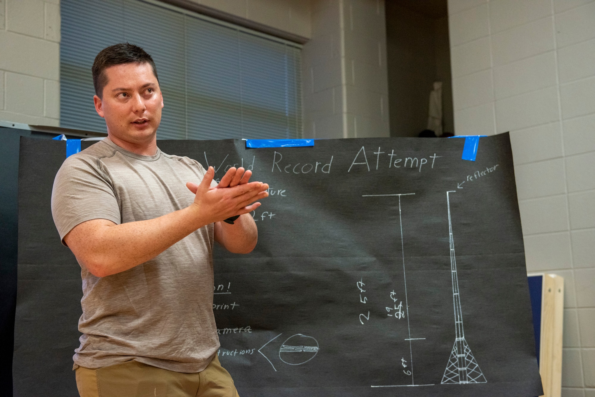 Airmen teaches volunteers how to construct the structure.