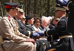 U.S. Army Brig. Gen. Joseph Reale, second from left, the deputy commanding general for sustainment, 29th Infantry Division, receives the flag that covered a Revolutionary War Soldier’s casket during a burial honors ceremony April 22, 2023, at the Camden Battlefield in South Carolina. Reale, the Maryland Army National Guard’s representative at the ceremony, served with the 175th Infantry Regiment, a unit present at the Battle of Camden in 1780 and of which many of the Americans honored at the ceremony were also members.