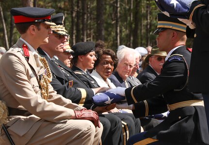 U.S. Army Brig. Gen. Joseph Reale, second from left, the deputy commanding general for sustainment, 29th Infantry Division, receives the flag that covered a Revolutionary War Soldier’s casket during a burial honors ceremony April 22, 2023, at the Camden Battlefield in South Carolina. Reale, the Maryland Army National Guard’s representative at the ceremony, served with the 175th Infantry Regiment, a unit present at the Battle of Camden in 1780 and of which many of the Americans honored at the ceremony were also members.