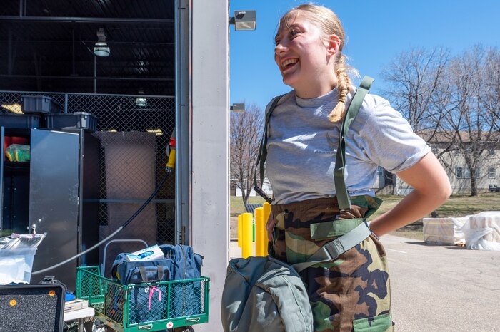 Airman 1st Class Claire Reed, a 133rd Civil Engineering Squadron emergency management specialist, dons protective chemical gear at the Minneapolis-St. Paul Air Reserve Station, Minnesota, April 13, 2023. The operations were part of a joint training exercise between the 934th Airlift Wing and the Minnesota Air National Guard's 133rd Airlift Wing. (U.S. Air Force photo by Senior Airman Matthew Reisdorf)