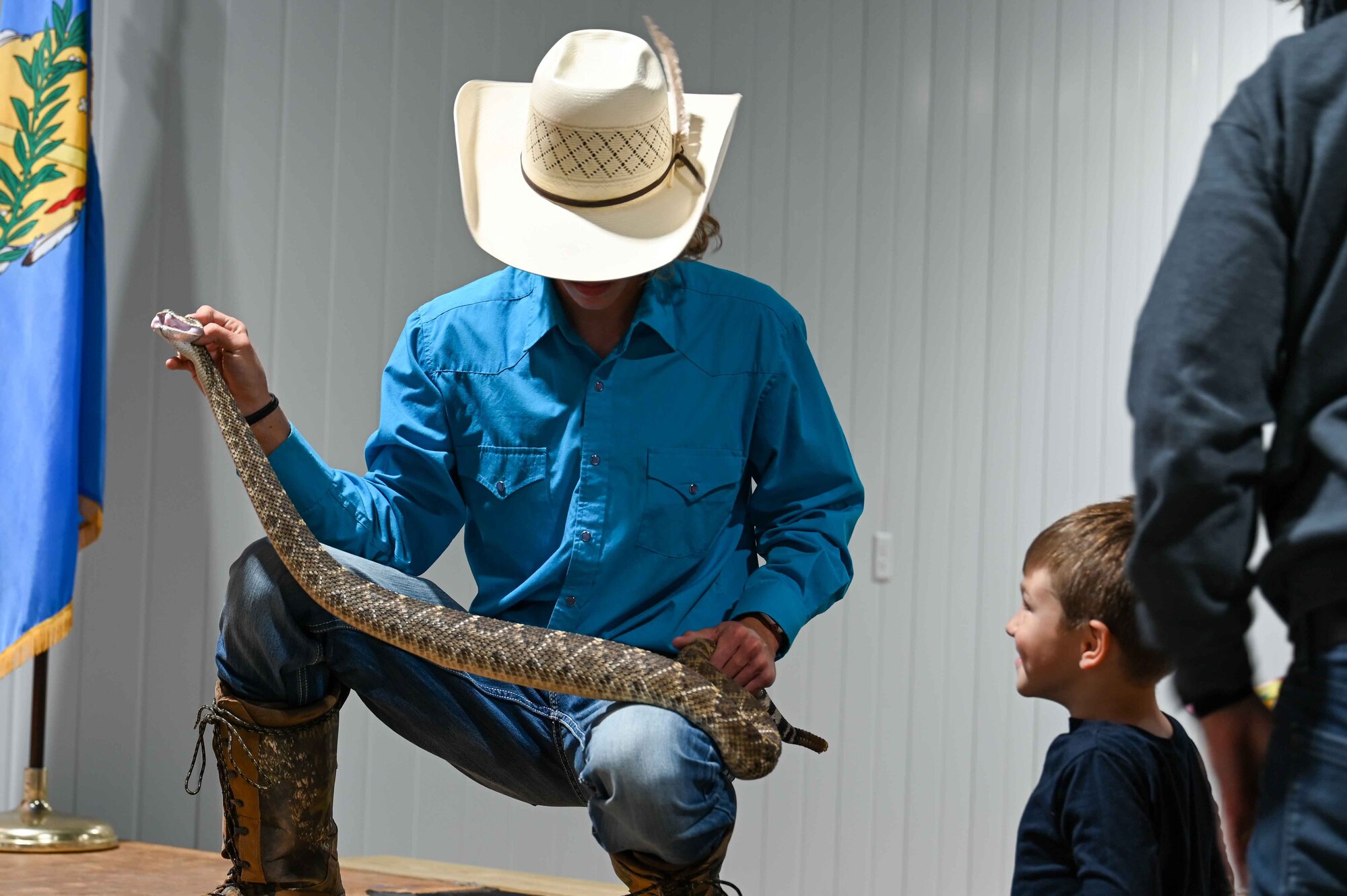 A member of the Shortgrass Rattlesnake Association shows off a rattlesnake at an event hosted by the Altus Chamber of Commerce’s Committee of 100 in Altus, Oklahoma, April 24, 2023.Four members of the Shortgrass Rattlesnake Association came to handle the snakes so Airmen and their families could see them up close. (U.S. Air Force photo by Airman 1st Class Heidi Bucins)