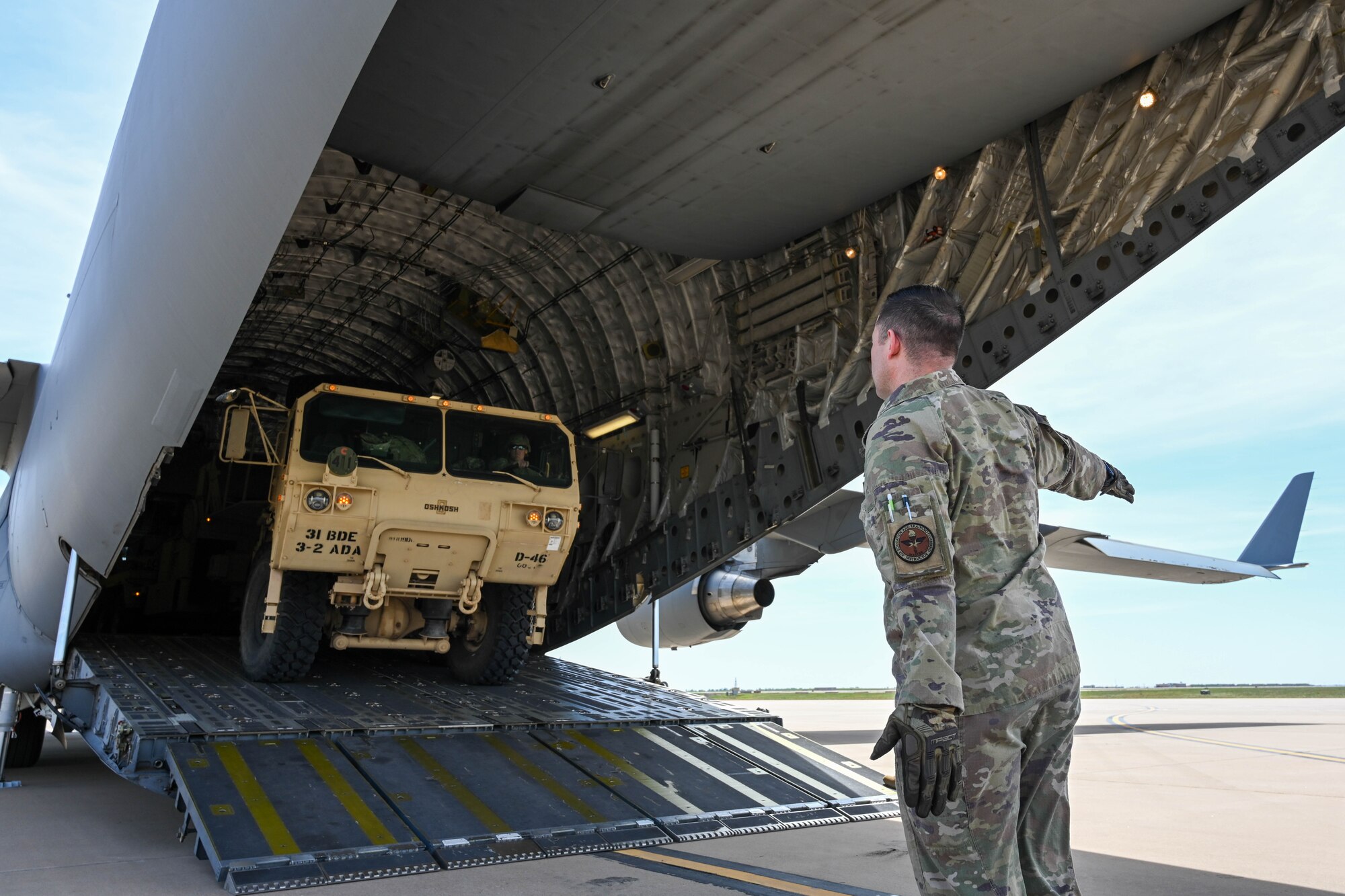 U.S. Air Force Master Sgt. Jeremy John, 58th Airlift Squadron training flight superintendent, helps guide a mobile Patriot missile battery into a C-17 Globemaster III at Altus Air Force Base (AFB), Oklahoma, April 19, 2023. This training was an opportunity for loadmasters and U.S. Airmen from the 97th Logistics Readiness Squadron to get hands-on experience with equipment they don’t see during their normal operations at Altus AFB. (U.S. Air Force photo by Senior Airman Trenton Jancze)