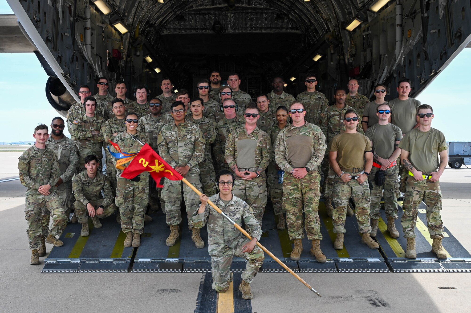 U.S. Airmen from the 97th Air Mobility Wing pose for a photo with U.S. Soldiers from the 3rd Battalion, 2nd Air Defense Artillery Regiment from the 31st Air Defense Artillery Brigade stationed at Fort Sill, Oklahoma, on the flightline at Altus Air Force Base, Oklahoma, April 19, 2023. About 30 Soldiers and 13 vehicles from the 3-2 ADA BDE participated in training, while three loadmaster instructors from the 58th Airlift Squadron and six Airmen from the 97th Logistics Readiness Squadron supported their training. (U.S. Air Force photo by Senior Airman Trenton Jancze)