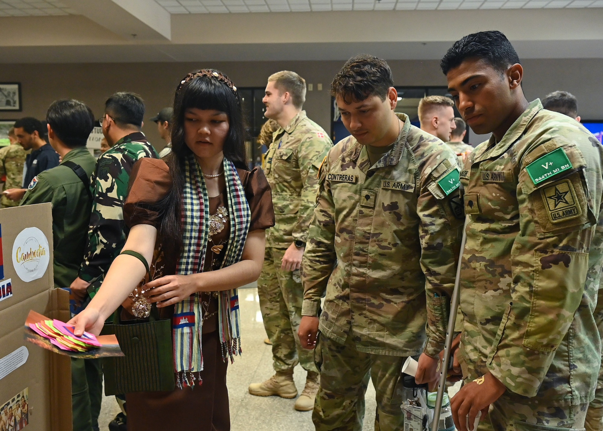 Joint service members assigned to the 17th Training Wing visit the Cambodian language and culture booth at the Goodfellow Air Force Base and Angelo State University Language and Culture Fair in San Angelo, Texas, April 27, 2023. Each booth featured interactive elements for visitors to learn about the cultures and languages found across the globe. (U.S. Air Force photo by Airman 1st Class Zach Heimbuch)