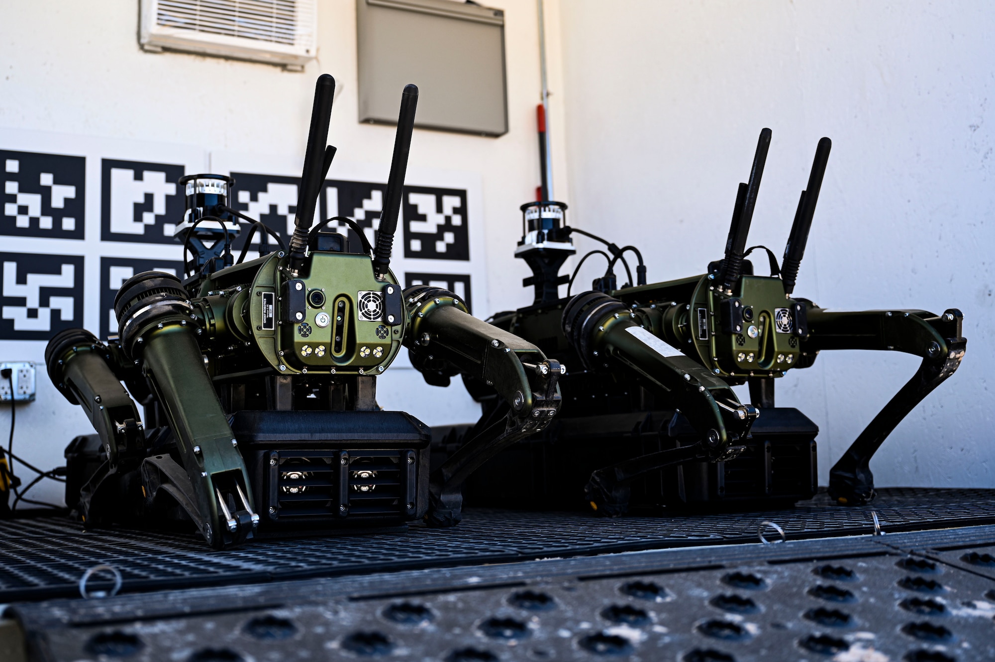 A pair of Vision 60 Q-UGV ground robots charge at their station at Holloman Air Force Base, New Mexico, April 17, 2023. The Vision 60 will be employed by the 49th SFS to monitor and secure the base boundaries for maximum security and reinforcement. (U.S. Air Force photo by Airman 1st Class Isaiah Pedrazzini)