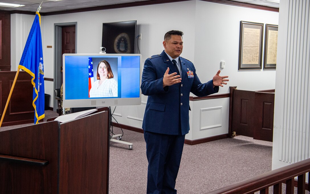 U.S. Air Force Col. Brian Banas, 673d Air Base Wing Judge Advocate staff judge advocate, speaks to gathered coworkers and friends of Kimberly Pfender, a retired U.S. Air Force master sergeant, during a 673d ABW/JA courtroom dedication at Joint Base Elmendorf-Richardson, Alaska, April 6, 2023. Pfender served with distinction as both an Air Force non-commissioned officer and civil servant for a combined federal service of 28 years. (U.S. Air Force photo by Tech. Sgt. Curt Beach)