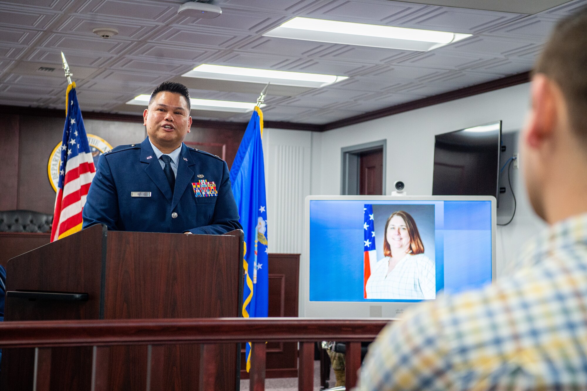 U.S. Air Force Col. Brian Banas, 673d Air Base Wing Judge Advocate staff judge advocate, speaks to gathered coworkers and friends of Kimberly Pfender, a retired U.S. Air Force master sergeant, during a 673d ABW/JA courtroom dedication at Joint Base Elmendorf-Richardson, Alaska, April 6, 2023. Pfender served with distinction as both an Air Force non-commissioned officer and civil servant for a combined federal service of 28 years. (U.S. Air Force photo by
Tech. Sgt. Curt Beach)