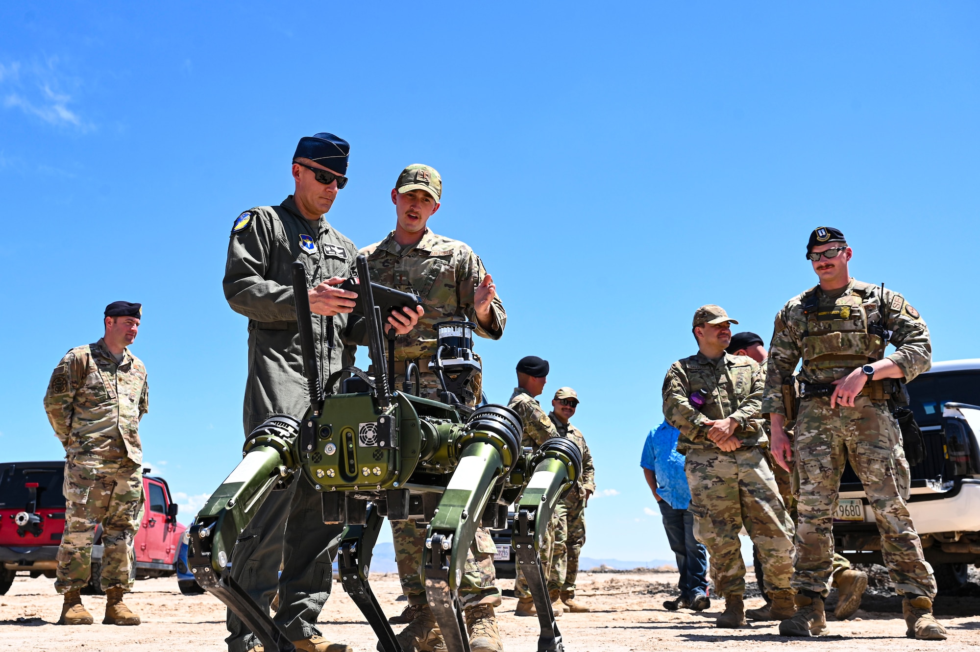 U.S. Air Force 2nd Lt. Brock Southwick, 49th Security Forces logistics officer in charge, instructs U.S. Air Force Col. Justin Spears, 49th Wing commander, on how to pilot the Vision 60 Q-UGV ground robot at Holloman Air Force Base, New Mexico, April 17, 2023. The 49th SFS is responsible for the protection and safety of both the Airmen and civilian personnel on base and provides a secure environment that enables the development of the world's best professional remotely piloted aircraft enterprise. (U.S. Air Force photo by Airman 1st Class Isaiah Pedrazzini)