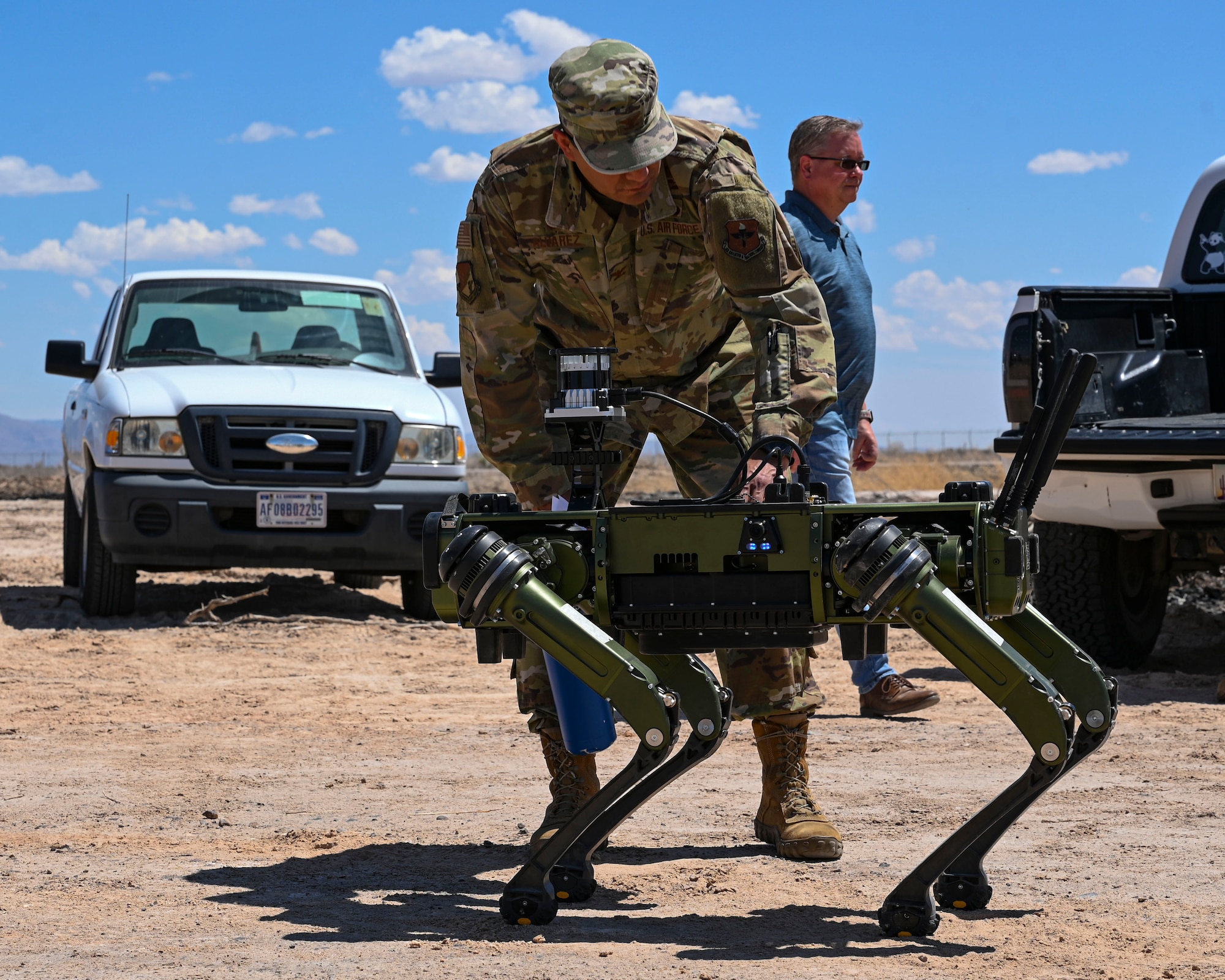 Col. Juan Alvarez, 49th Civil Engineer Squadron commander, inspects a Vision 60 Q-UGV ground robot at Holloman Air Force Base, New Mexico, April 17, 2023. The Vision 60 will be employed by the 49th SFS to monitor and secure the base boundaries for maximum security and reinforcement. (U.S. Air Force photo by Airman 1st Class Isaiah Pedrazzini)