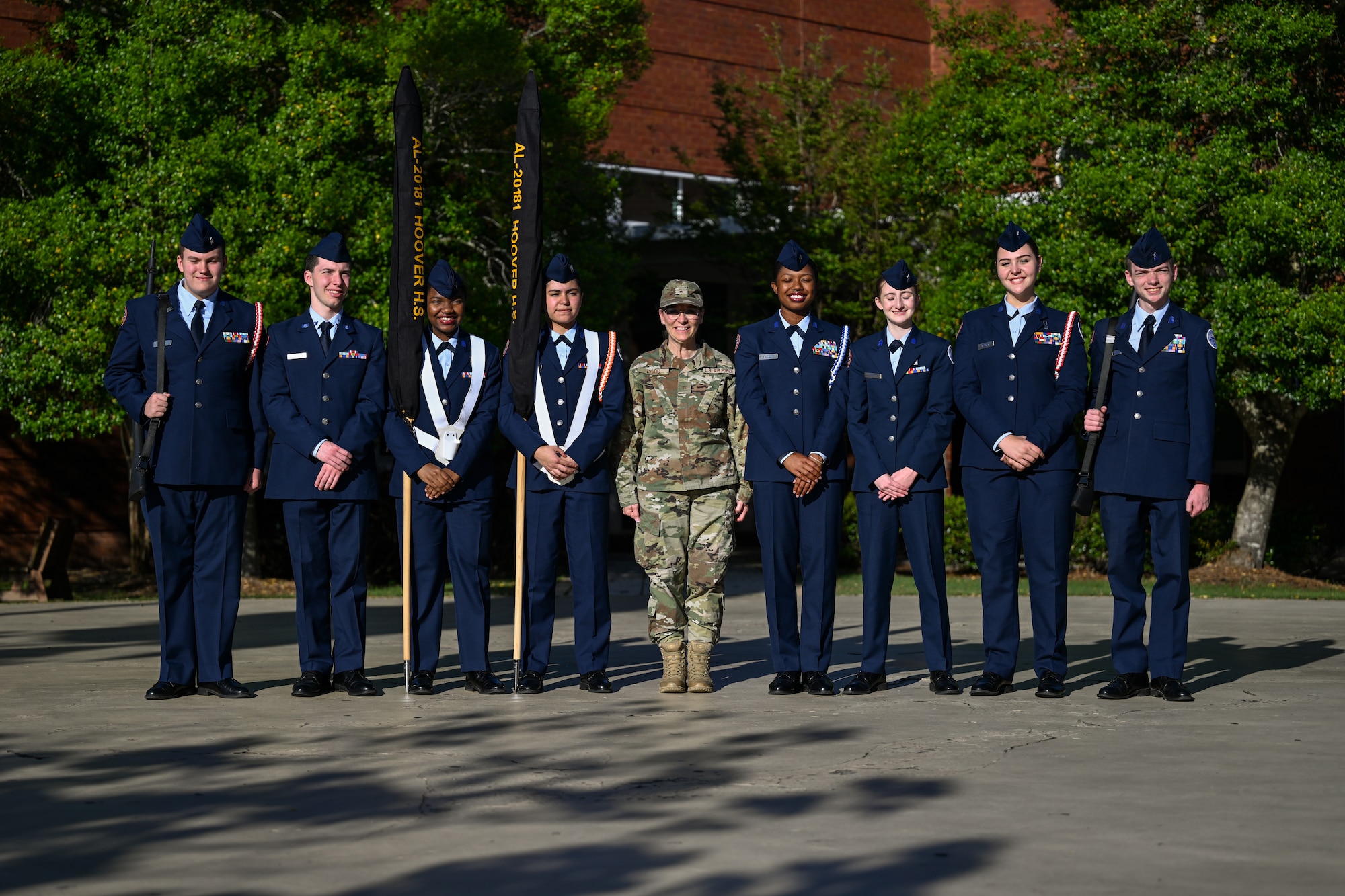 Brig. Gen. Lisa M. Craig, deputy commander, Air Force Recruiting Service, center, poses with cadets from the Hoover High School, Ala. Air Force Junior ROTC drill team
