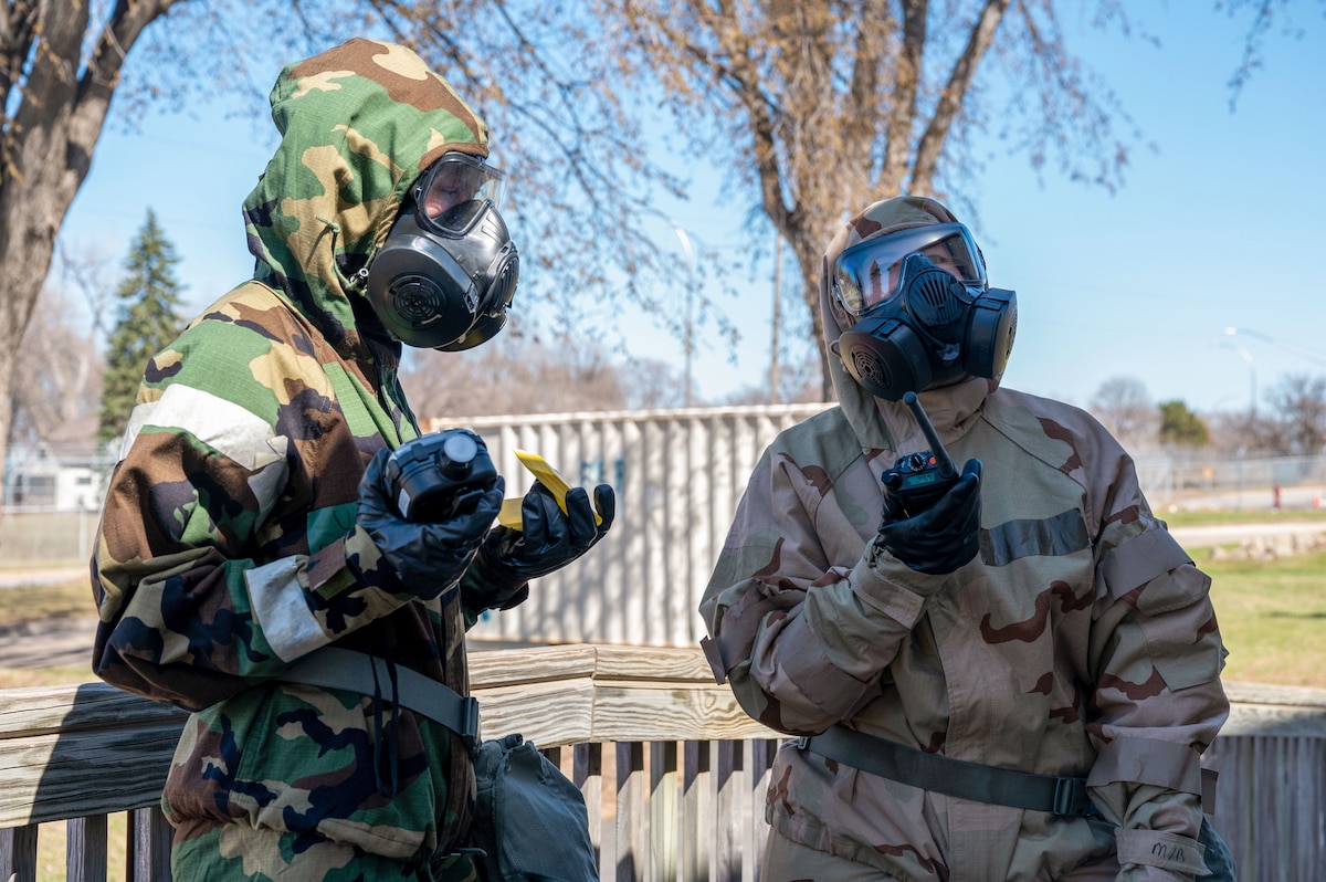Senior Airman Anna Alger, a 934th Civil Engineering Squadron emergency management team member, right, and Airman 1st Class Skylar Mcdonalds, a 133rd Civil Engineering Squadron emergency management specialist, communicate with their EM teams during an exercise at the Minneapolis-St. Paul Air Reserve Station, Minnesota, April 13, 2023. The operations were part of a joint training exercise between the 934th Airlift Wing and the Minnesota Air National Guard's 133 AW. (U.S. Air Force photo by Senior Airman Matthew Reisdorf)