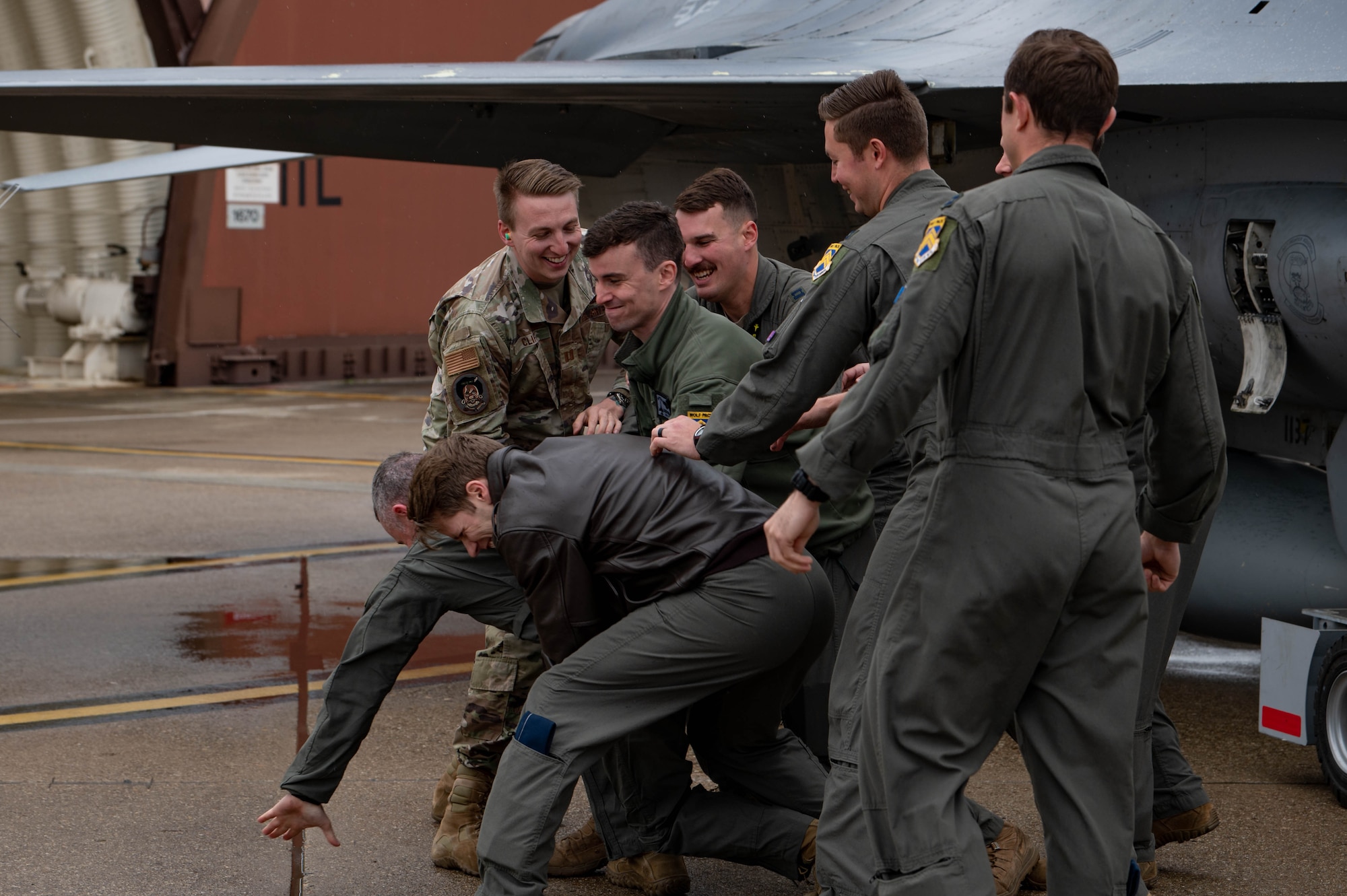 Airmen from the 80th Fighter Squadron, tackle Col. John ‘Wolf 2’  Caldwell, 8th Fighter Wing vice commander, after his fini-flight at Osan Air Base, Republic of Korea, April 25, 2023.