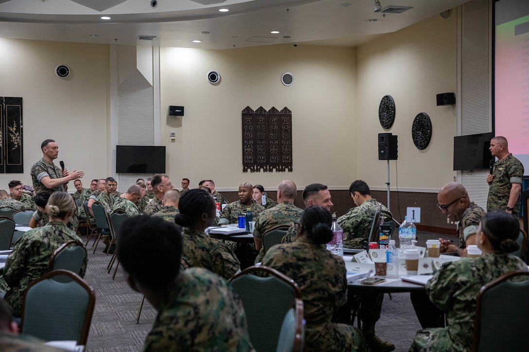 U.S. Navy Lt. Grant Eubanks,a chaplain with 1st Marine Aircraft Wing, left, answers U.S. Navy Cdr. Greg Coates, a chaplain with Marine Corps Installation West, right, question during the Professional Development Training Course, at Crow’s Nest, on Camp Shields, Okinawa, Japan, March 14, 2023. PDTC is a 3 day course to train chaplains and religious program specialists by working together in their units to facilitate various faith groups and allowing them to freely practice their religion.  The course also taught chaplains and RP’s about how to help Marines with their personal lives such as their finances issues, emotional health and help provide a safe place. (U.S. Marine Corps photo by Cpl. Martha Linares)