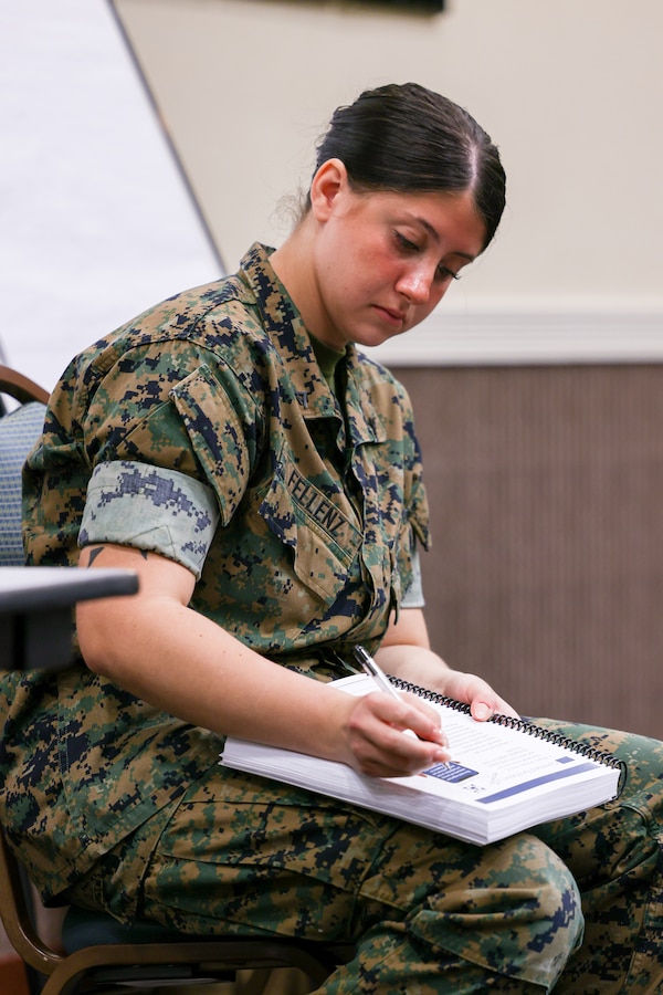 U.S. Marine Corps Lance Cpl. Cassandra Fellenz, originally a heavy equipment mechanic with 9th Engineering Support Battalion, 3rd Marine Logistics Group, now a chaplain's assistant, takes notes during the Professional Development Training Course, at Crow’s Nest, on Camp Shields, Okinawa, Japan, March 14, 2023. PDTC is a three-day course to train chaplains and religious program specialists by working together in their units to facilitate various faith groups and allowing them to freely practice their religion.  The course also taught chaplains and RP’s about how to help Marines with their personal lives such as their finances issues, emotional health and help provide a safe place. (U.S. Marine Corps photo by Lance Cpl. Jesse Davis)