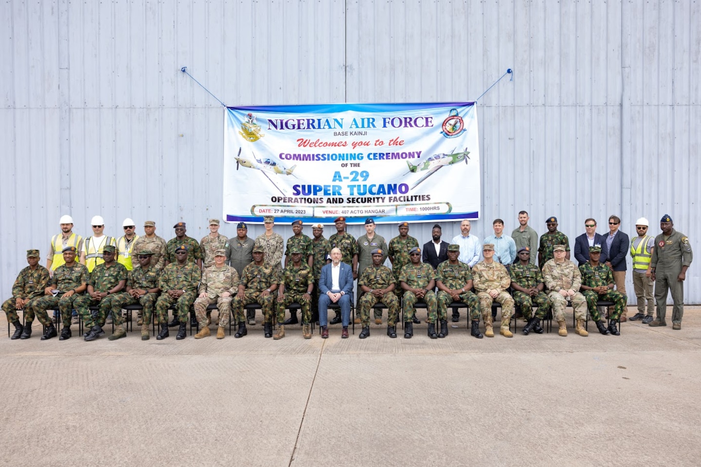 A large group of people gather together for a formal photo