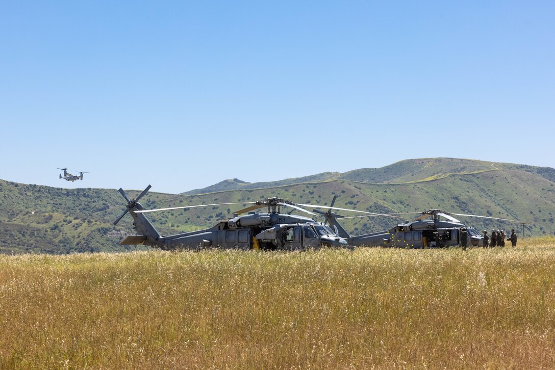 U.S. Navy MH-60 Seahawk and Marine Corps MV-22B Osprey, top left, helicopters participate in a command and control training event, part of a final exercise of Weapons and Tactics Instructor (WTI) course 2-23, at Camp Pendleton, California, April 21, 2023. WTI is a seven-week training event hosted by Marine Aviation Weapons and Tactics Squadron One, providing standardized advanced tactical training and certification of unit instructor qualifications to support Marine aviation training and readiness, and assists in developing and employing aviation weapons and tactics. (U.S. Marine Corps photo by Lance Cpl. Padilla)