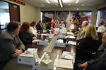 Group of people sitting in a conference room.