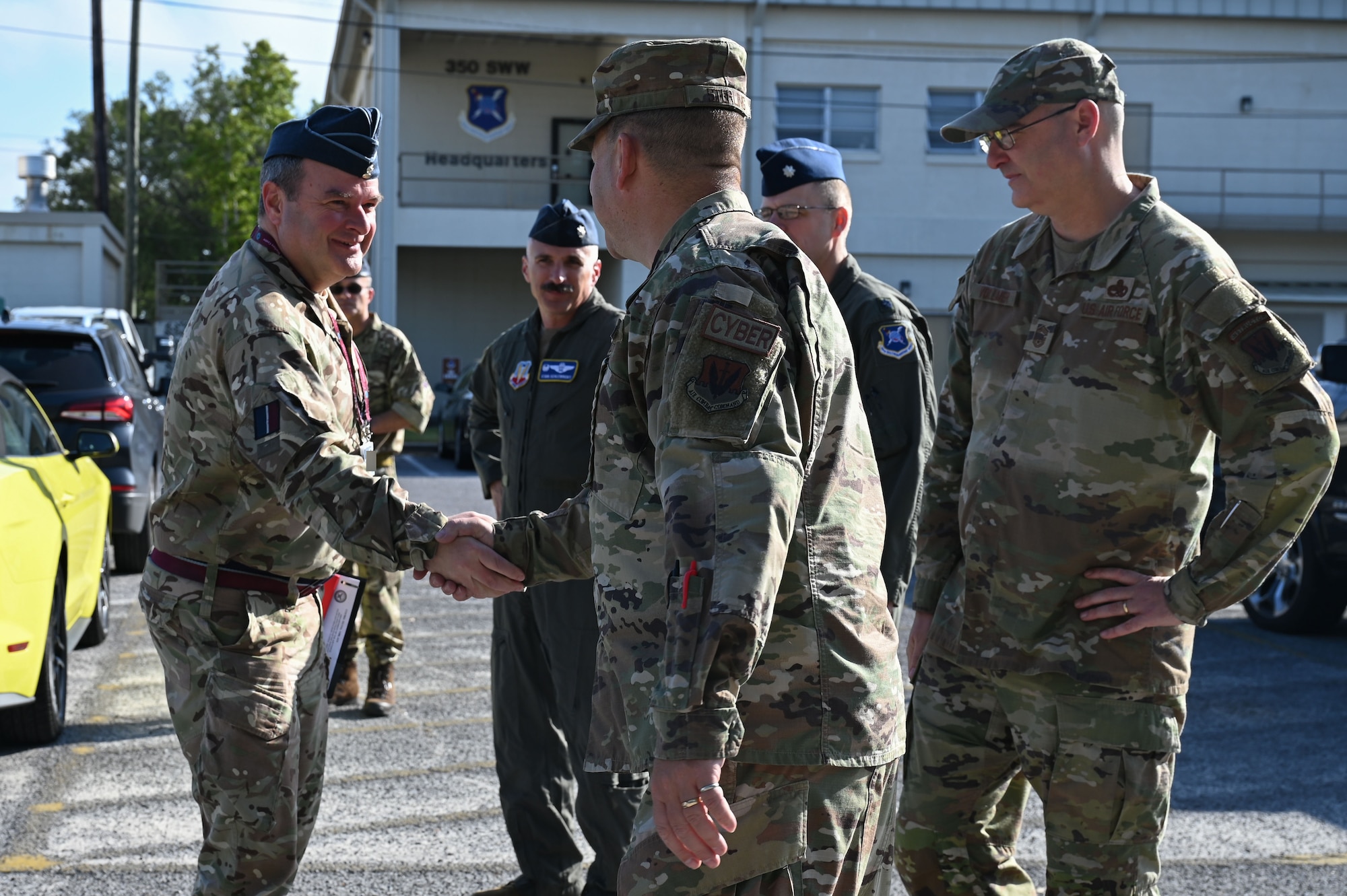 U.S. Air Force Chief Master Sgt. Michael F. Sterling, 850th Spectrum Warfare Group senior enlisted leader, greets Royal Air Force Commodore Blythe Crawford, Air and Space Warfare Center commandant, at Eglin Air Force Base, Fla., April 26, 2023. The 350th SWW serves as the Air Force’s first EMS focused wing on enhancing air component commanders’ ability to synchronize, integrate and execute EMS capabilities across all domains and platforms. (U.S. Air Force photo by Staff Sgt. Ericka A. Woolever)