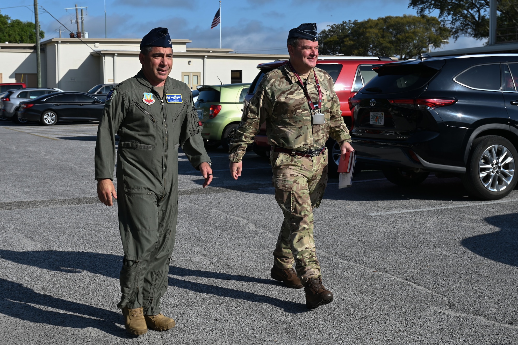 U.S. Air Force Col. Josh Koslov, 350th Spectrum Warfare Wing commander, left, and Royal Air Force Commodore Blythe Crawford, Air and Space Warfare Center commandant, right, walk together after greeting one another at Eglin Air Force Base, Fla., April 26, 2023. The EMS is a global domain which all militaries operate within. Aligning the 350th SWW strategic and tactical goals with our allies will fasten the pace our coalition forces can dominate the spectrum and prevent our adversaries the ability to operate within the spectrum. (U.S. Air Force photo by Staff Sgt. Ericka A. Woolever)