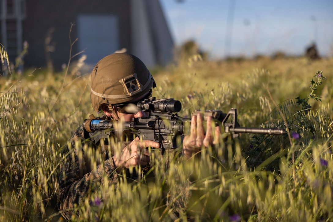 U.S. Marine Corps Cpl. Fox Jurgiel, a Field Artillery Sensor Support Marine with Hotel Battery, 2nd Battalion, 10th Marine Regiment, 2d Marine Division provides security during a HIMARS Rapid Insertion on the Decimomannu Air Base in Sardinia Italy, April 26, 2023. HIRAIN operations provide lethal and accurate fire to targets all across the globe.