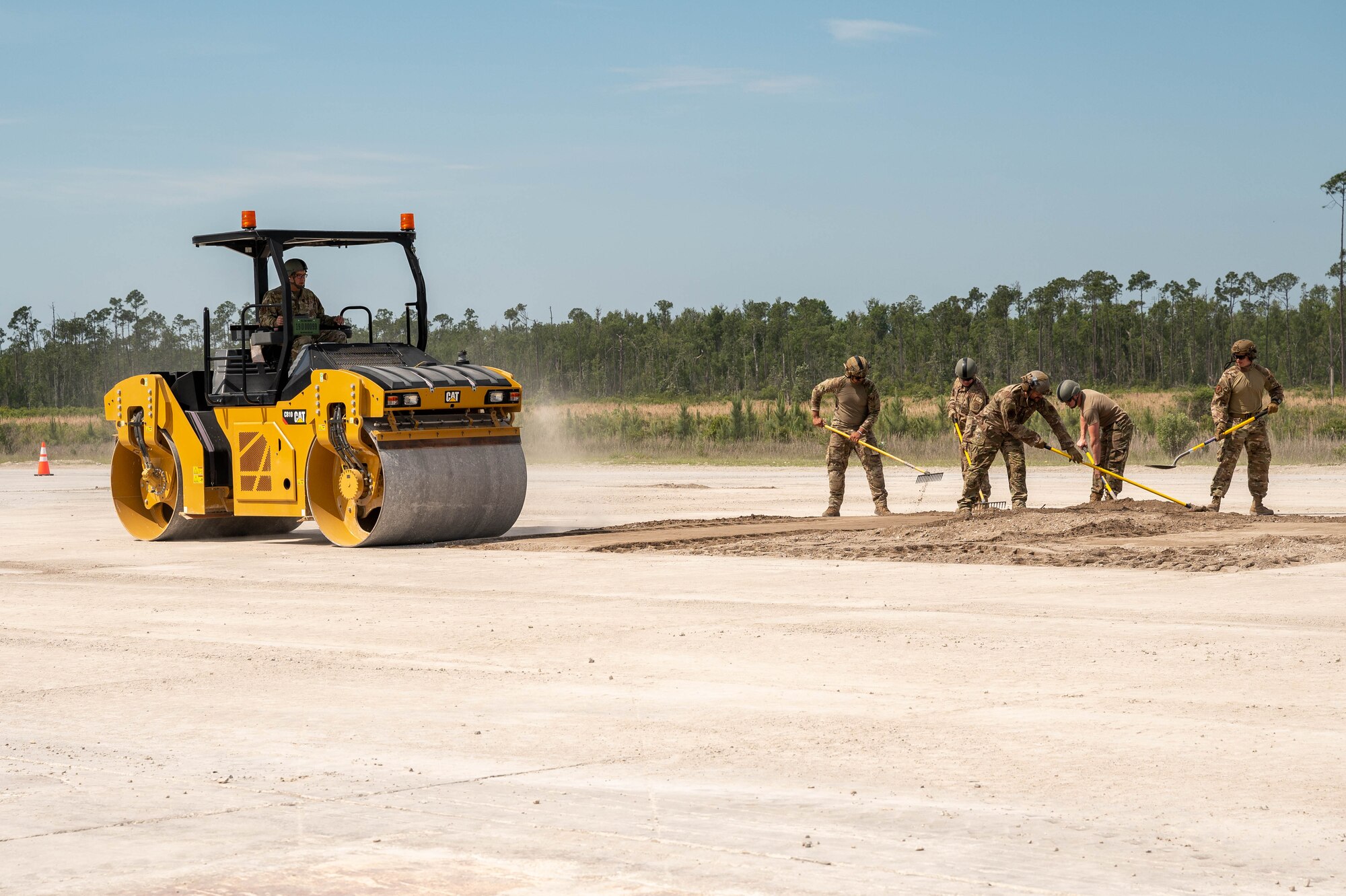 Members of the 914th Civil Engineer Squadron, Air Force Reserve Command, attempt an airfield damage crater repair.