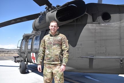 Nevada Army Guard Spc. Jake Evans next to a medical evacuation UH-60L Black Hawk helicopter during a break in training April 17, 2023, in Reno, Nev. Evans is the 2023 Nevada Army Guard Soldier of the Year and is set to travel to Hawaii to represent Nevada in the Region VII Best Warrior contest.