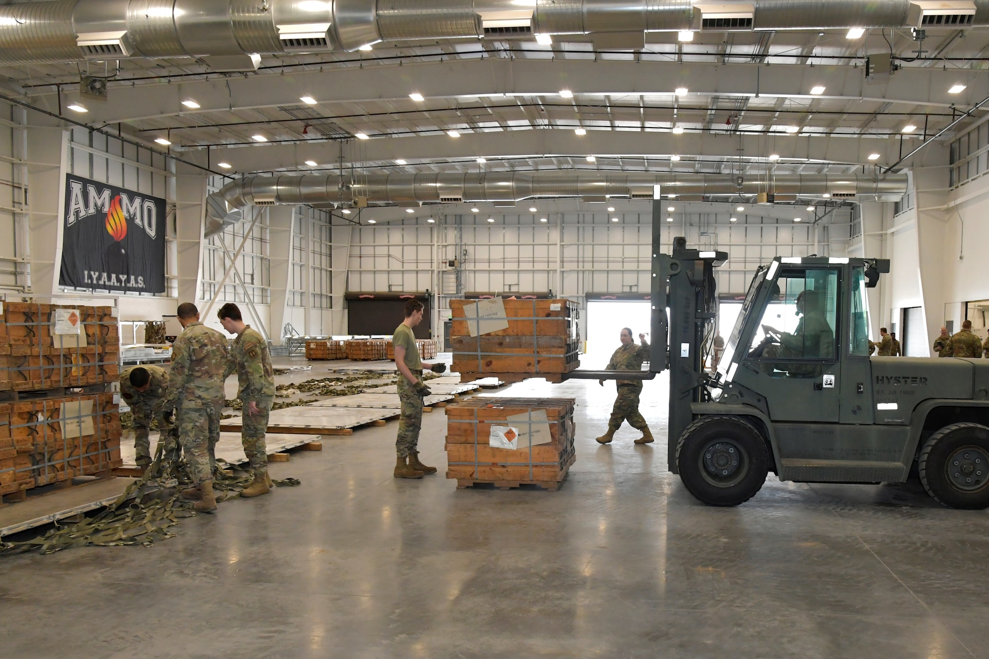 People in a warehouse with a forklift