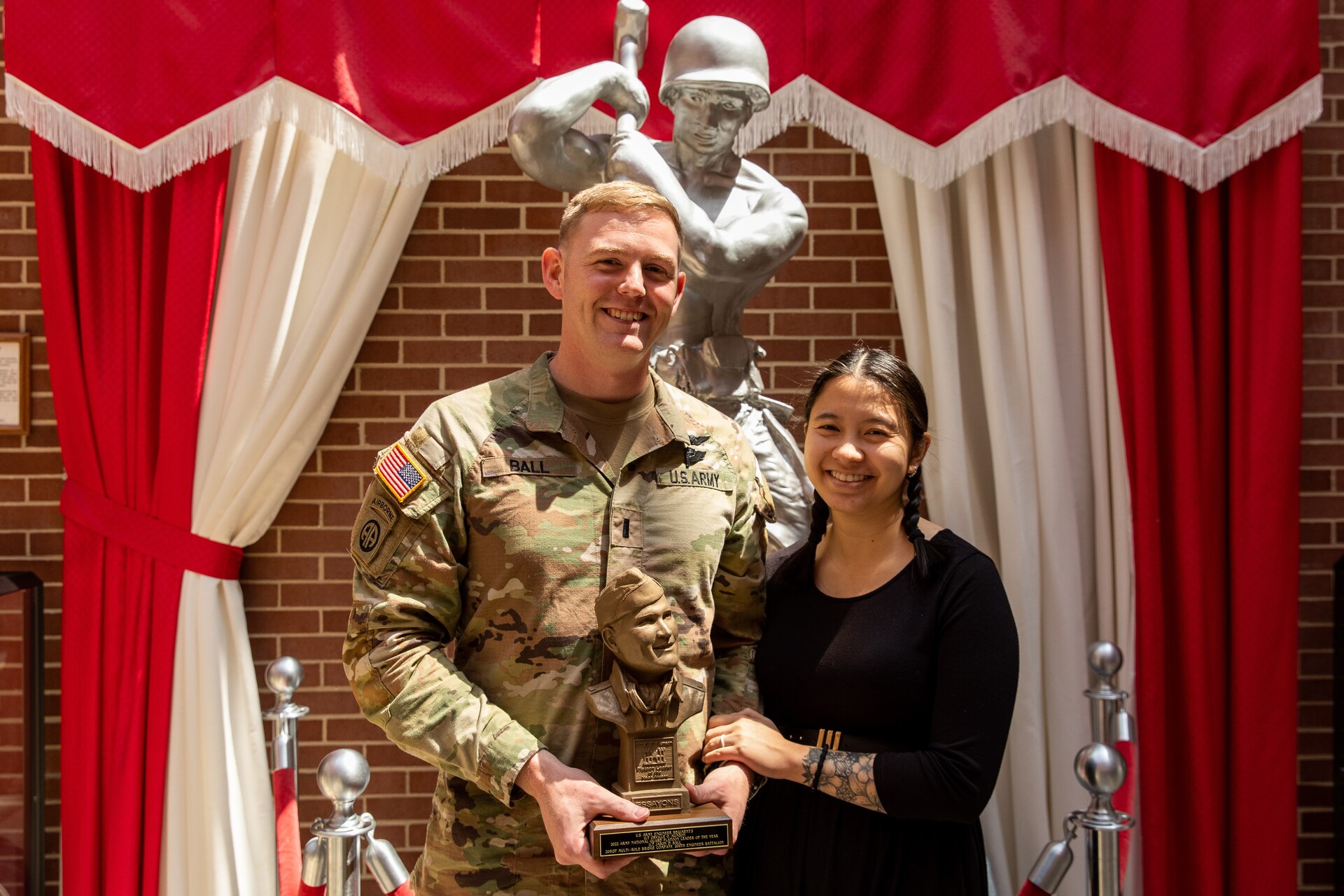 U.S. Army 1st Lt. Jason Bell poses with his wife, Dr. Michelle Baltam, after receiving the Lt. Orville Munson Award at the U.S. Army Engineer Regimental School at Fort Leonardwood, Missouri on April 28, 2023. The award is given annually to honor an engineer lietuenant or warrant officer platoon leader in the Active Army and Army National Guard in recognition of outstanding contributions to military engineering by demonstrated technical and leadership ability. (U.S. Army National Guard photo by Sgt. 1st Class Andrew Dickson)
