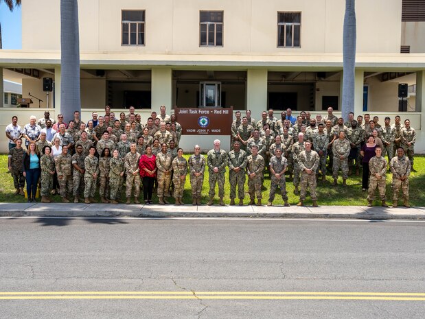 Members of Joint Task Force-Red Hill (JTF-RH) pose for a group photo after a patching ceremony at its headquarters on Ford Island, Hawaii, April 28, 2023.