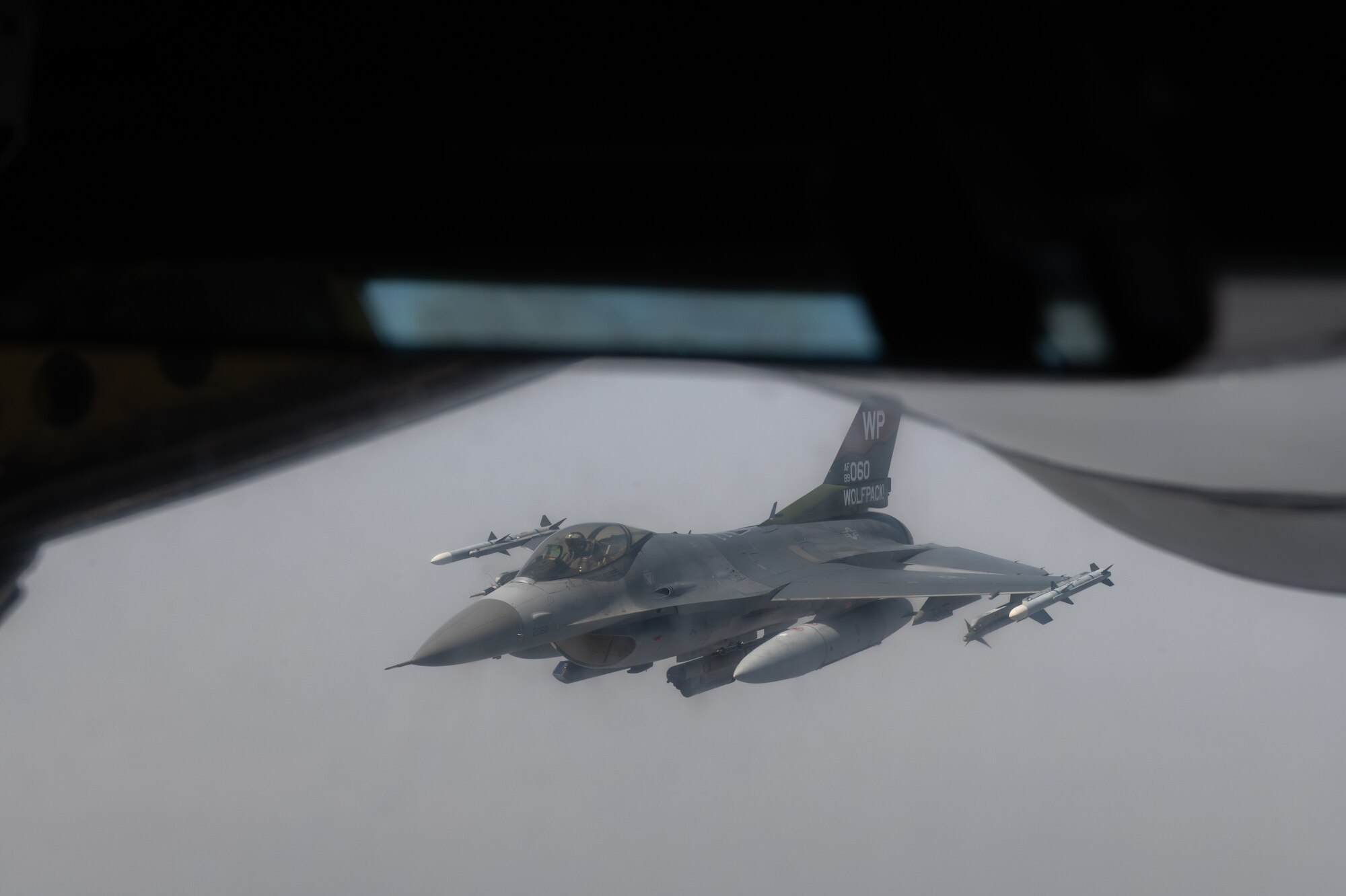 A U.S. Air Force F-16 Fighting Falcon pulls away from a KC-135 Stratotanker after refueling during Korea Flight Training Apr. 21, 2023. KFT is a regularly scheduled training event designed to enhance the combat readiness of U.S. and Republic of Korea forces to maintain peace in the region. (U.S. Air Force photo by Senior Airman Cedrique Oldaker)