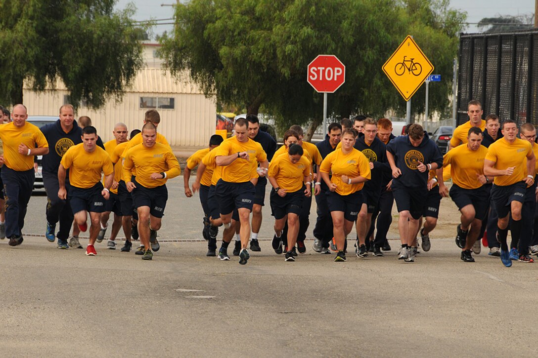 A group of sailors run together.