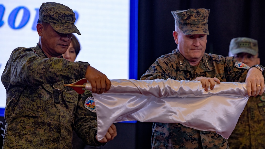 U.S. and Philippine senior military leaders furl the exercise flag at the closing ceremony to conclude Balikatan 23 at Camp Aguinaldo, Manila, Philippines, April 28, 2023. Over the last three weeks, more than 17,600 personnel trained shoulder-to-shoulder across the Philippines’ northern Luzon and Palawan, increasing proficiency in maritime security, amphibious operations, live-fire training, urban operation, aviation operations, counterterrorism, and humanitarian assistance and disaster relief. (U.S. Marine Corps photo by Cpl. Tyler Andrews)