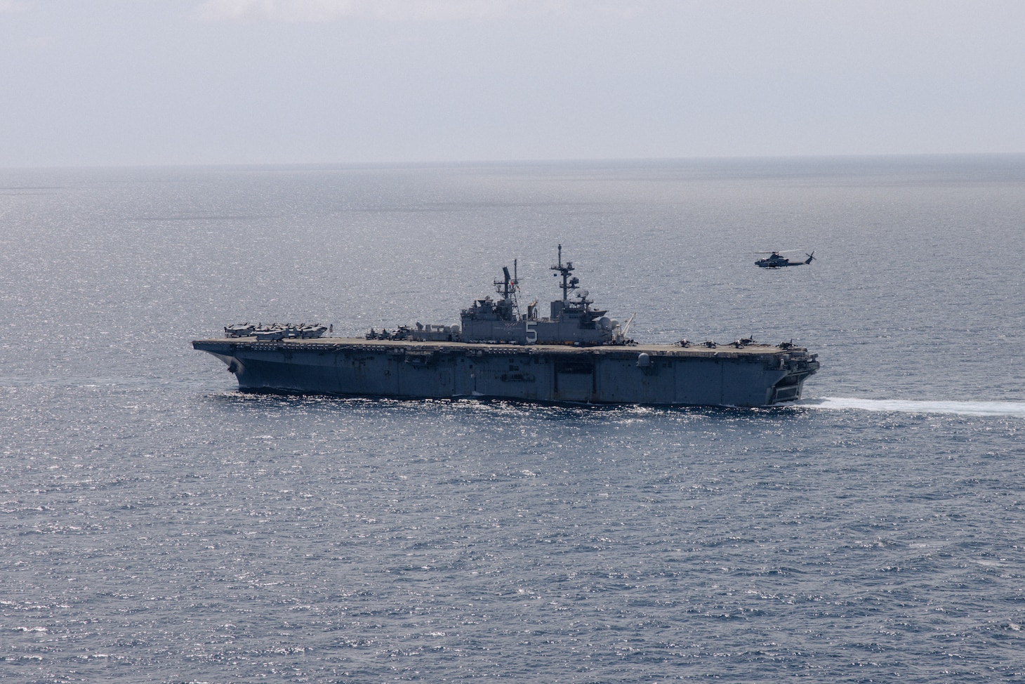 The U.S. Navy Wasp-class amphibious assault ship USS Bataan (LHD 5) conducts a strait transit and Defense of the Amphibious Task Force (DATF) drill during Amphibious Ready Group/MEU Exercise (ARGMEUEX) while underway in the Atlantic Ocean, April 26, 2023. DATF integrates Marine Corps and Navy capabilities, including aircraft, crew-served weapon systems, snipers and electronic warfare, to defend the ships in a wide range of combat situations.  ARGMEUEX is the second at-sea exercise in the MEU’s Pre-deployment Training Program. (U.S. Marine Corps photo by Cpl. Kyle Jia)