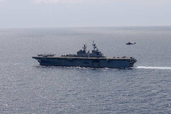 The U.S. Navy Wasp-class amphibious assault ship USS Bataan (LHD 5) conducts a strait transit and Defense of the Amphibious Task Force (DATF) drill during Amphibious Ready Group/MEU Exercise (ARGMEUEX) while underway in the Atlantic Ocean, April 26, 2023. DATF integrates Marine Corps and Navy capabilities, including aircraft, crew-served weapon systems, snipers and electronic warfare, to defend the ships in a wide range of combat situations.  ARGMEUEX is the second at-sea exercise in the MEU’s Pre-deployment Training Program. (U.S. Marine Corps photo by Cpl. Kyle Jia)