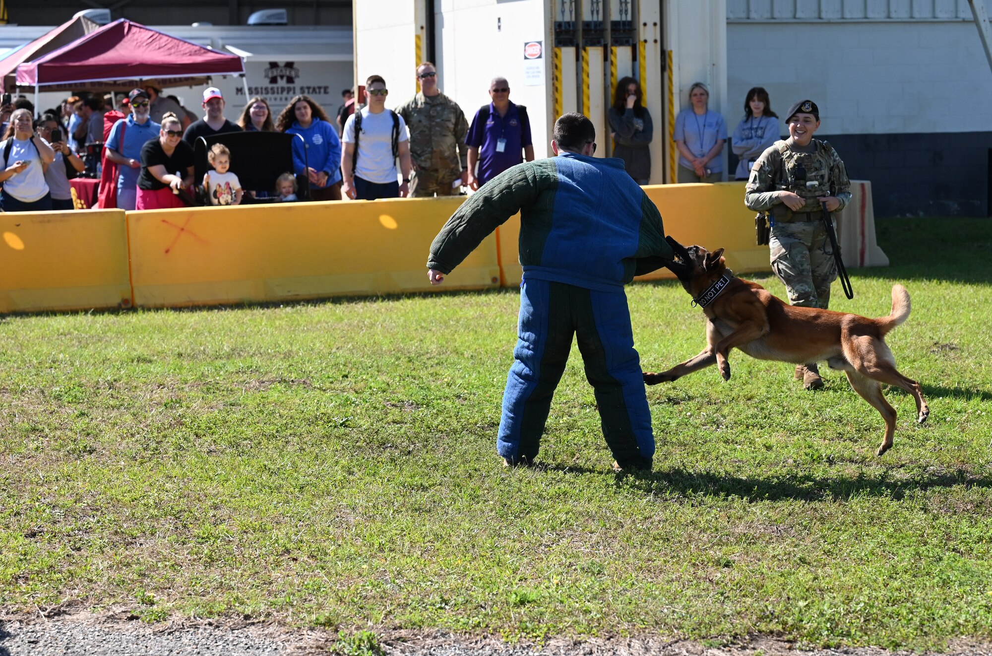U.S. Air Force Staff Sgts. Dustin Hadsock and Ryan Wood, 81st Security Forces Squadron military working dog handlers, and Victor, 81st SFS MWD, participate in a MWD demonstration at the STEM Expo on Keesler Air Force Base, Mississippi, April 28, 2023. The Science, Technology, Engineering, and Math Expo was an educational opportunity for student to learn about career opportunities in the Air Force and on the Gulf Coast. (U.S. Air Force photo by Airman 1st Class Elizabeth Davis)