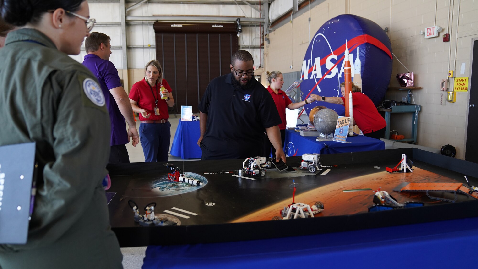 Remote controlled miniature space vehicles are displayed at the NASA table in the STEM Expo at Hangar 4 on Keesler Air Force Base, Mississippi, April 28, 2023. The Science, Technology, Engineering, and Math Expo was an educational opportunity for student to learn about career opportunities in the Air Force and on the Gulf Coast. (U.S. Air Force photo by Airman 1st Class Elizabeth Davis)