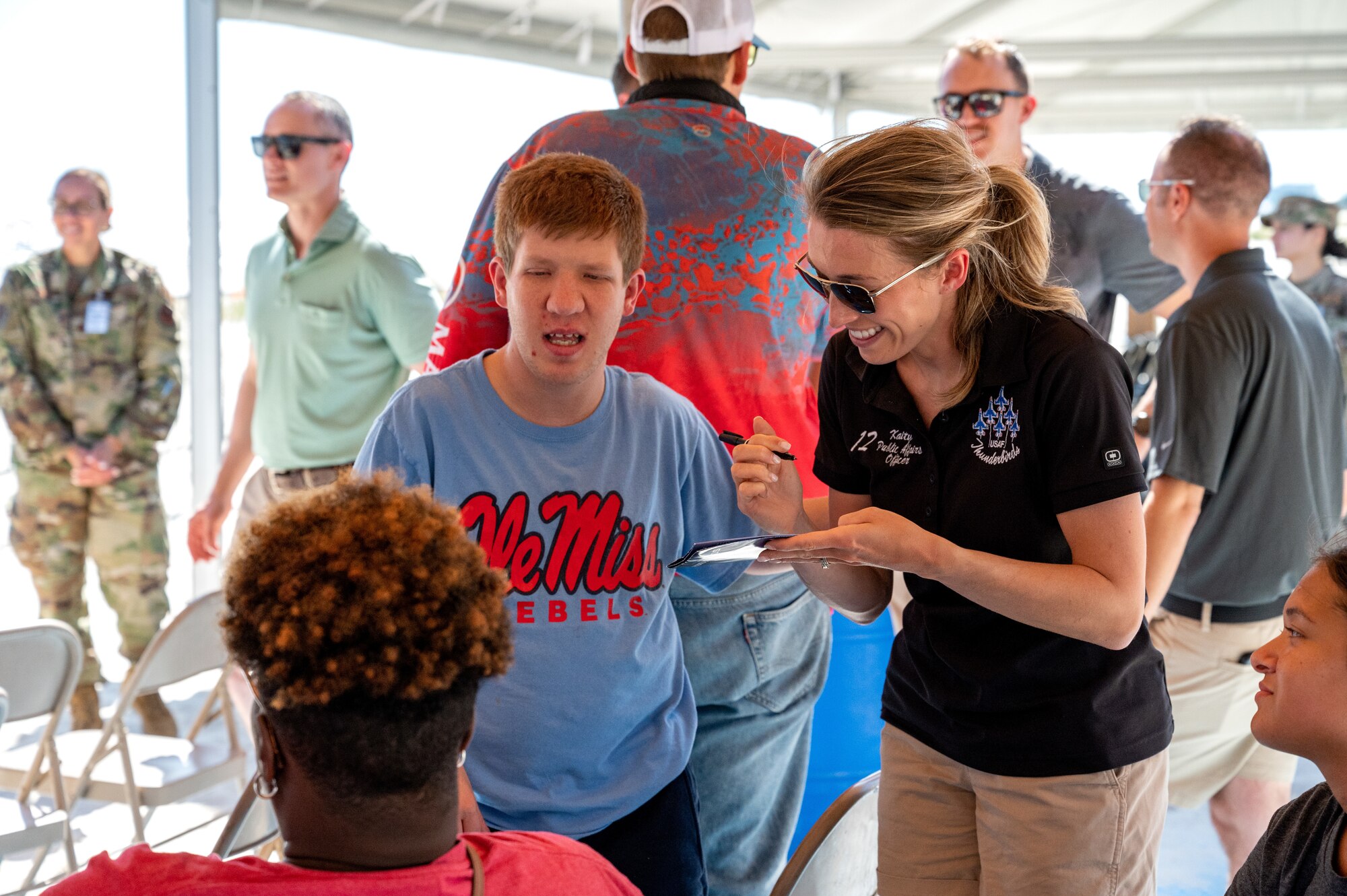 U.S. Air Force Capt. Kaity Toner, Thunderbird 12 public affairs officer, converses with Special Olympics Mississippi athletes and guests during a Thunderbirds meet and greet at Biloxi Beach in Biloxi, Mississippi, April 28, 2023. SOMS athletes and their guests were able to view a practice session for the 2023 Thunder Over the Sound Air and Space Show and meet the Thunderbirds. (U.S. Air Force photo by Airman 1st Class Trenten Walters)