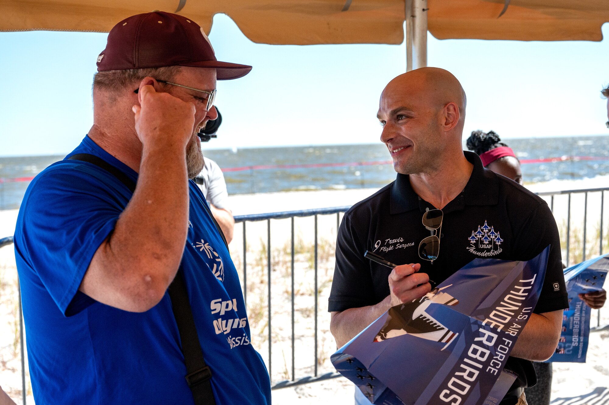 U.S. Air Force Maj. Travis Grindstaff, Thunderbird 9 flight surgeon, converses with Special Olympics Mississippi athletes and guests during a Thunderbirds meet and greet at Biloxi Beach in Biloxi, Mississippi, April 28, 2023. SOMS athletes and their guests were able to view a practice session for the 2023 Thunder Over the Sound Air and Space Show and meet the Thunderbirds. (U.S. Air Force photo by Airman 1st Class Trenten Walters)