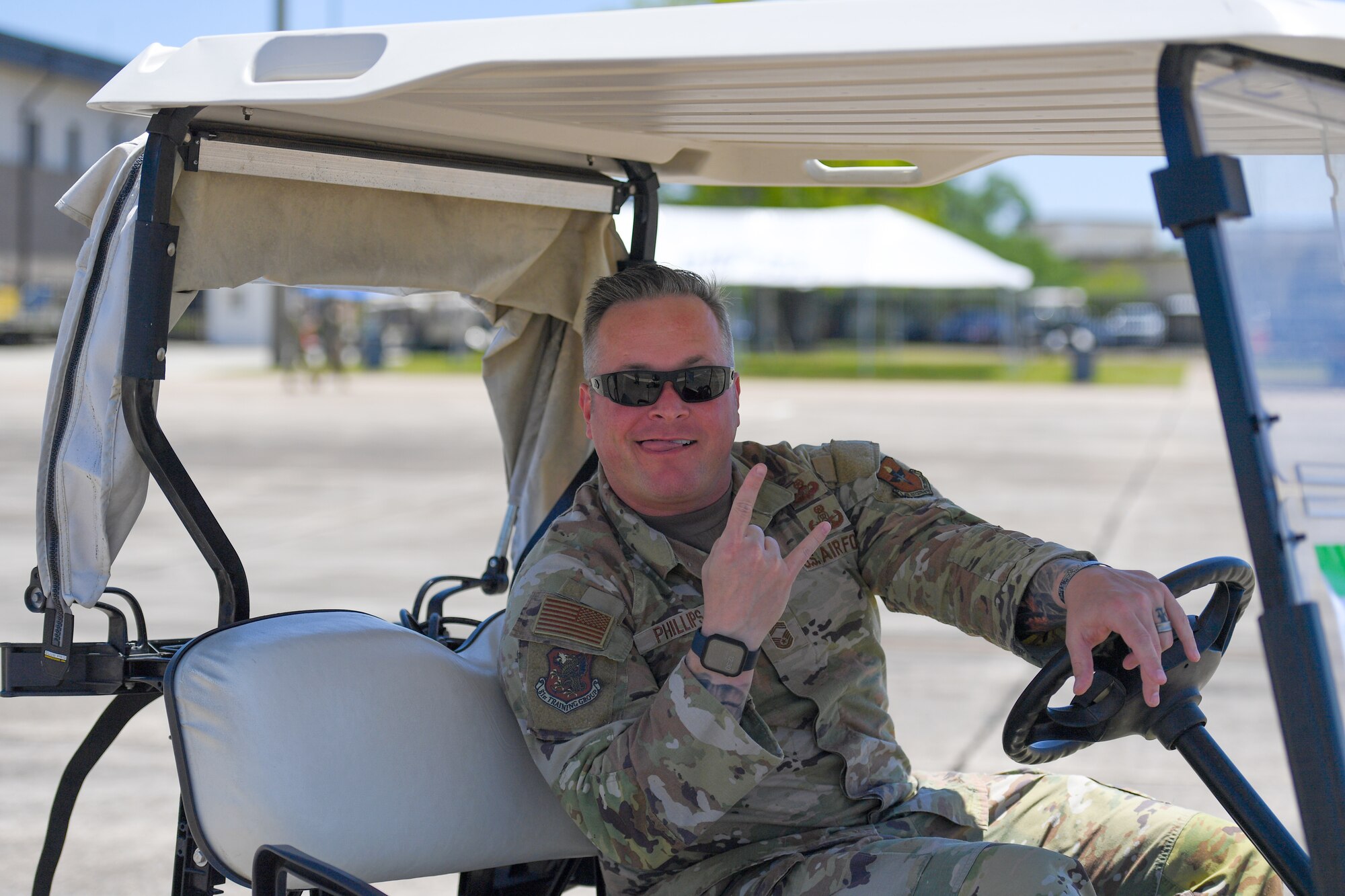 U.S. Air Force Chief Master Sgt. Jeremy Phillips, 81st Training Group senior enlisted leader, drives a golf cart during the 2023 Thunder Over the Sound Air and Space Show at Keesler Air Force Base, Mississippi, April 28, 2023. Thunder Over the Sound is a unique event where a military installation and its surrounding city jointly host an air show in two locations; Biloxi Beach and Keesler's flightline. (U.S. Air Force photo by Kemberly Groue)