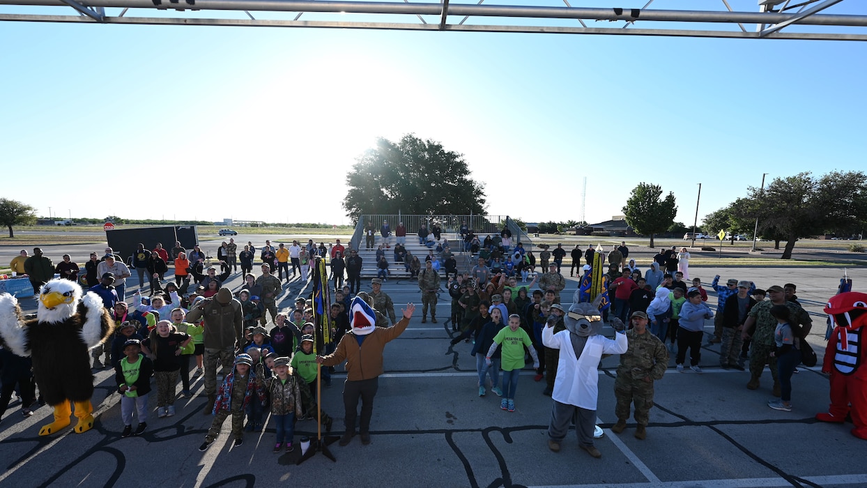Military children meet team mascots as part of Operation Kids at Goodfellow Air Force Base, Texas, April 29, 2023. Op Kids provided an opportunity for children in the base and local communities to familiarize themselves with activities commonly found at deployed locations. (U.S. Air Force photo by Airman 1st Class Zach Heimbuch)