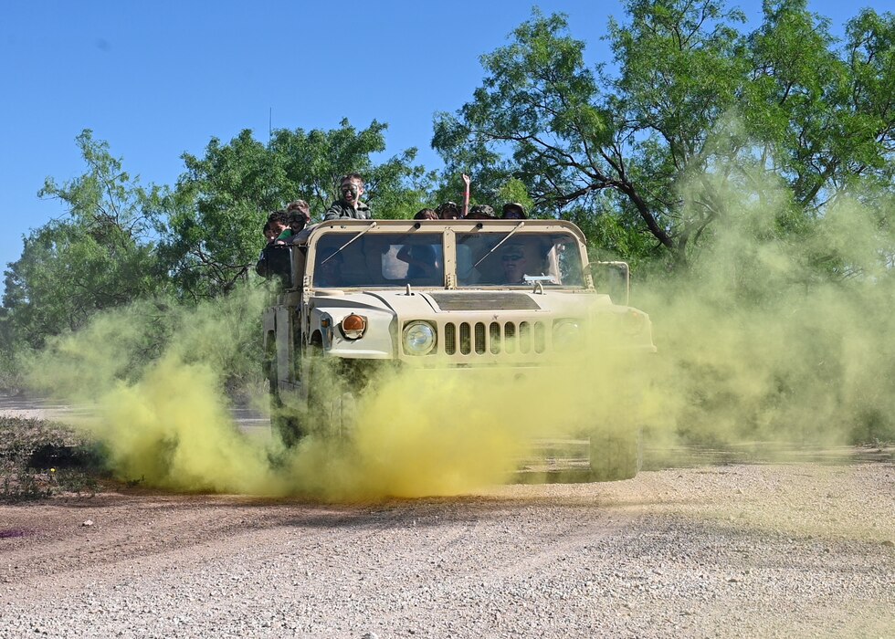 A Humvee moves through smoke during Operation Kids at Goodfellow Air Force Base, Texas, April 29, 2023. Op Kids allows military children to see what their parents experience on deployment and allows children from civilian families in San Angelo to understand Goodfellow's role in national defense. (U.S. Air Force photo by Airman 1st Class Zach Heimbuch)