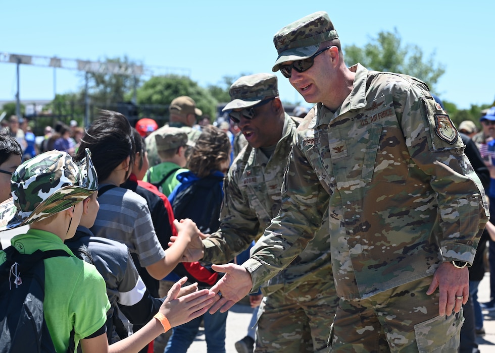 U.S. Air Force Col. Christopher Corbett, 17th Training Wing vice commander, high fives Operation Kids participants as part of the welcome home celebration, Goodfellow Air Force Base, Texas, April 29, 2023. Op Kids increases military children’s familiarization with the deployment process in a fun, safe, and engaging way. (U.S. Air Force photo by Airman 1st Class Zach Heimbuch)