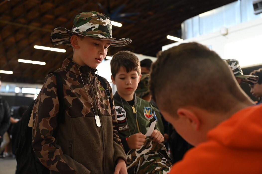 Participants in-process during Operation Kids at Goodfellow Air Force Base, Texas, April 29, 2023. During in-processing children received their orders, an ID card, dog tags, and face paint in preparation for the upcoming events. (U.S. Air Force photo by Airman 1st Class Madison Collier)