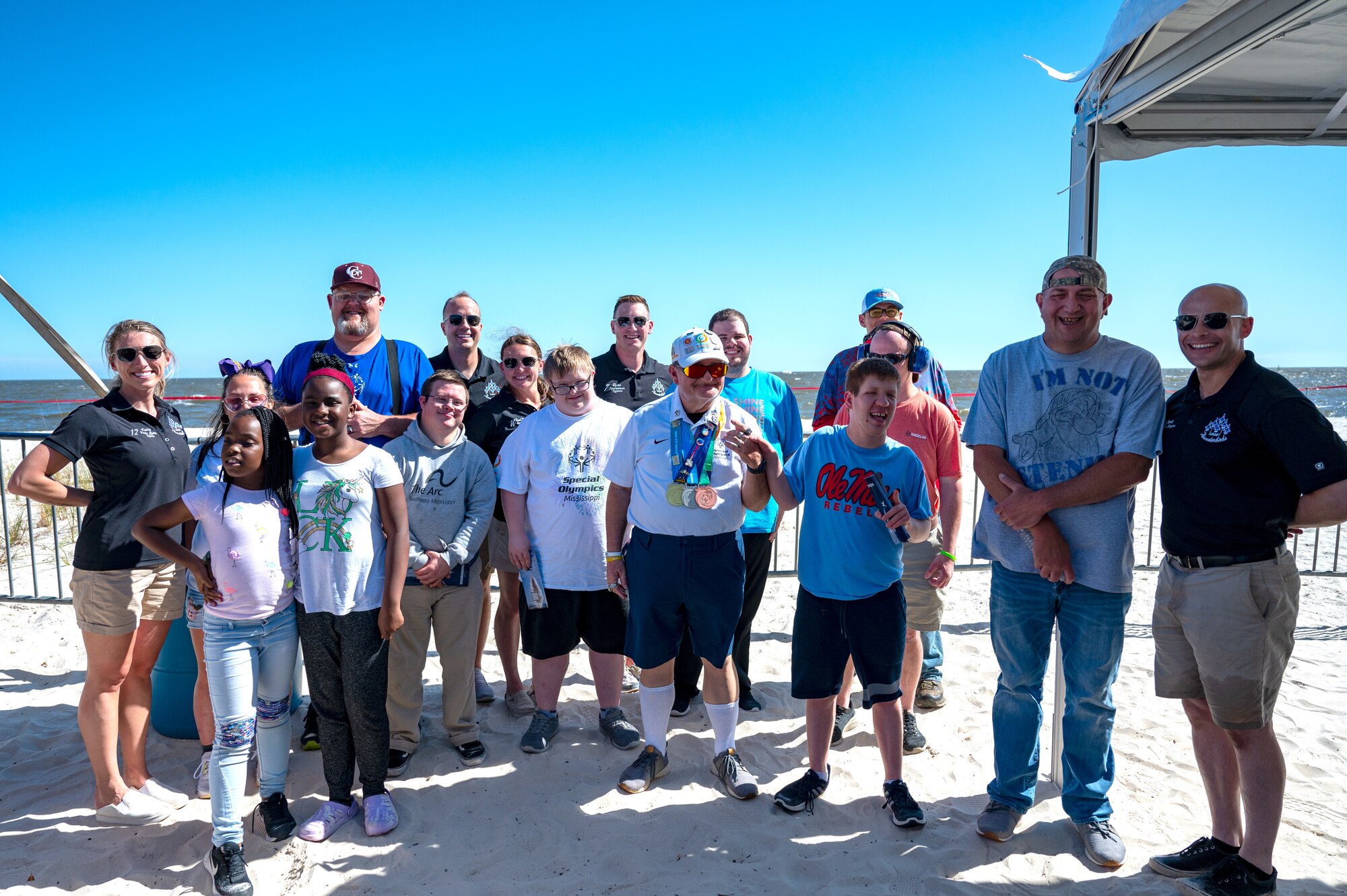 The Thunderbirds and Special Olympics Mississippi athletes and guests pose for a photo during a Thunderbirds meet and greet at Biloxi Beach in Biloxi, Mississippi, April 28, 2023. SOMS athletes and their guests were able to view a practice session for the 2023 Thunder Over the Sound Air and Space Show and meet the Thunderbirds. (U.S. Air Force photo by Airman 1st Class Trenten Walters)