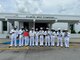 Sailors from the USS Cole (DDG-67) show thank you grams received from students at the Atlantic West Elementary School in Margate, Florida during Fleet Week Port Everglades. The US Navy has supported Fleet Week since 1990.