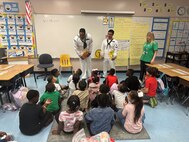 ailors from the USS Cole (DDG-67) read and answer questions for students at the Atlantic West Elementary School in Margate, Florida during Fleet Week Port Everglades. The US Navy has supported Fleet Week since 1990.